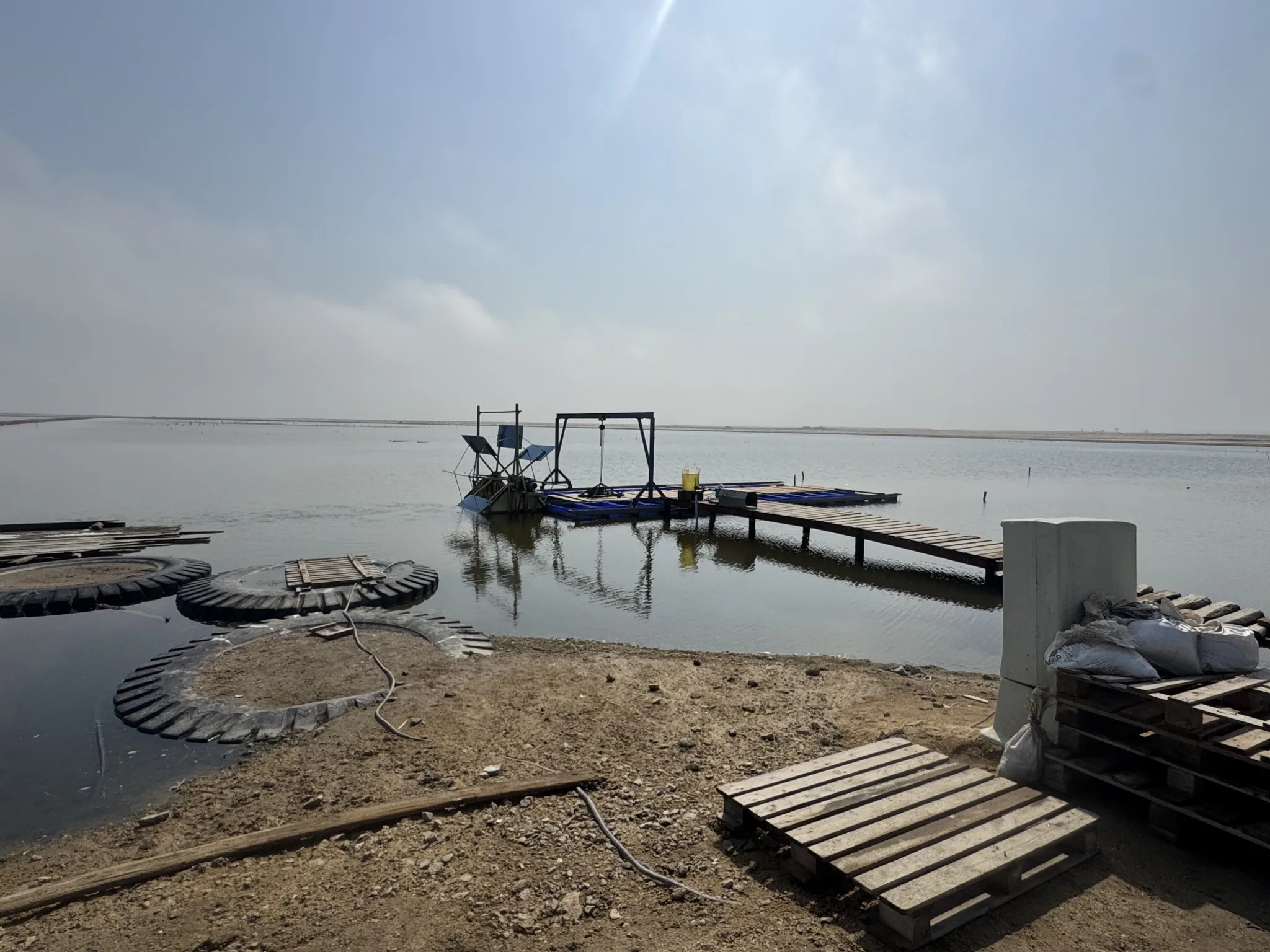 Floating paddle wheel raft and nursery tanks at the ponds